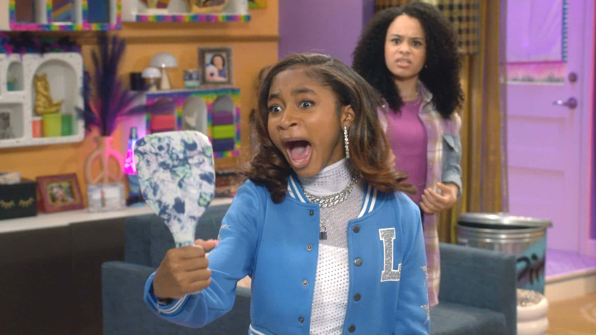 A Girl Is Holding A Blue Jacket And A White Toothbrush Background