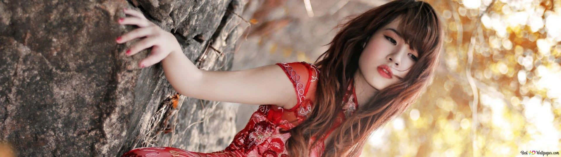 A Girl Is Leaning Against A Rock