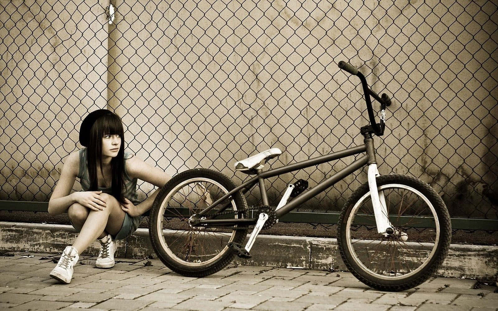 A Girl Is Sitting On A Bike Background