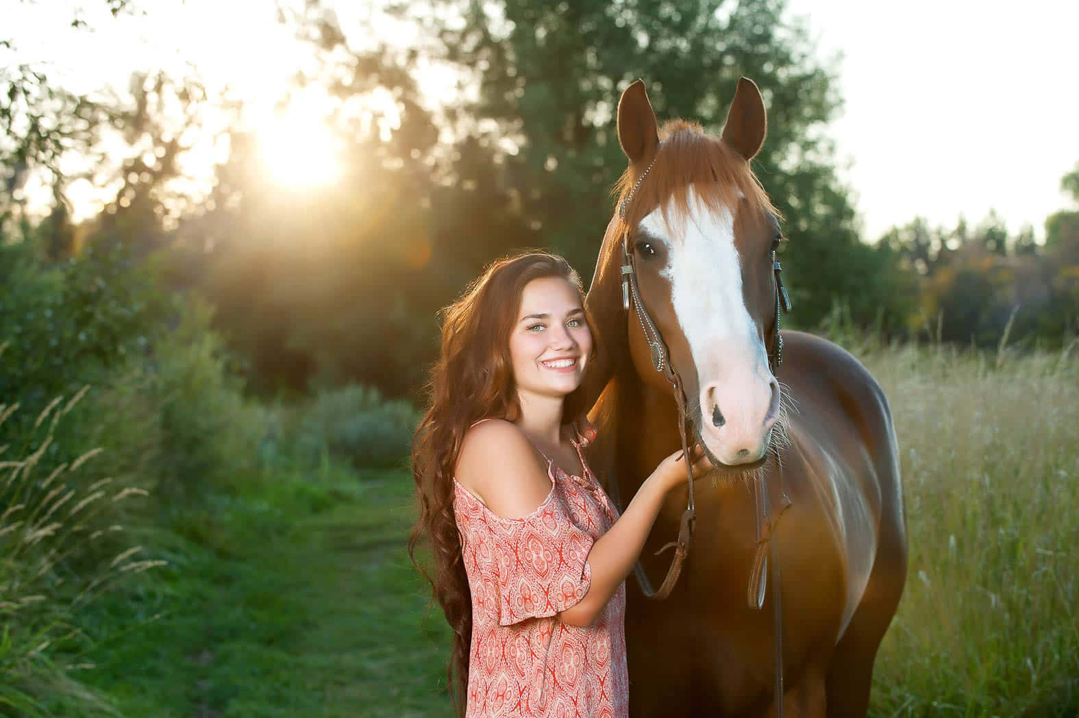 A Girl Poses With A Horse In A Field Background