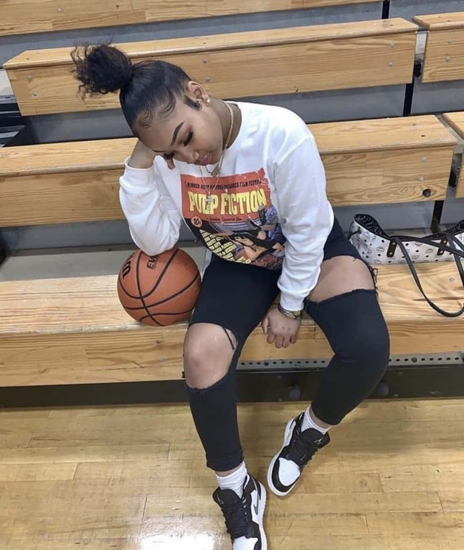 A Girl Sitting On A Bench With A Basketball Ball Background