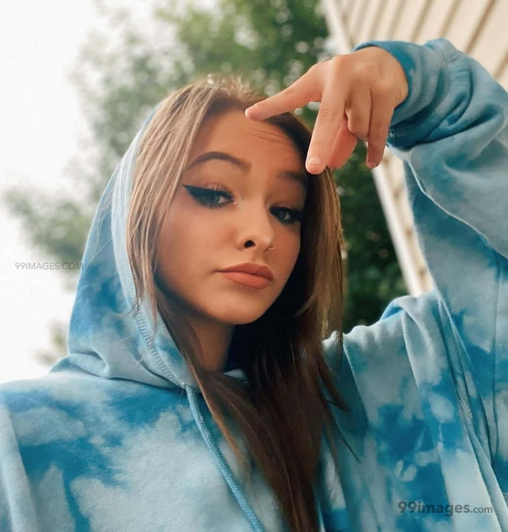 A Girl Wearing A Blue Tie Dye Hoodie Background