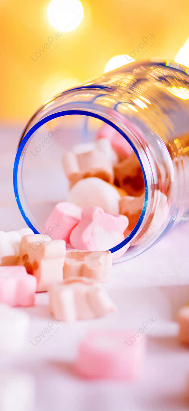 A Glass Bottle With Candy In It Background