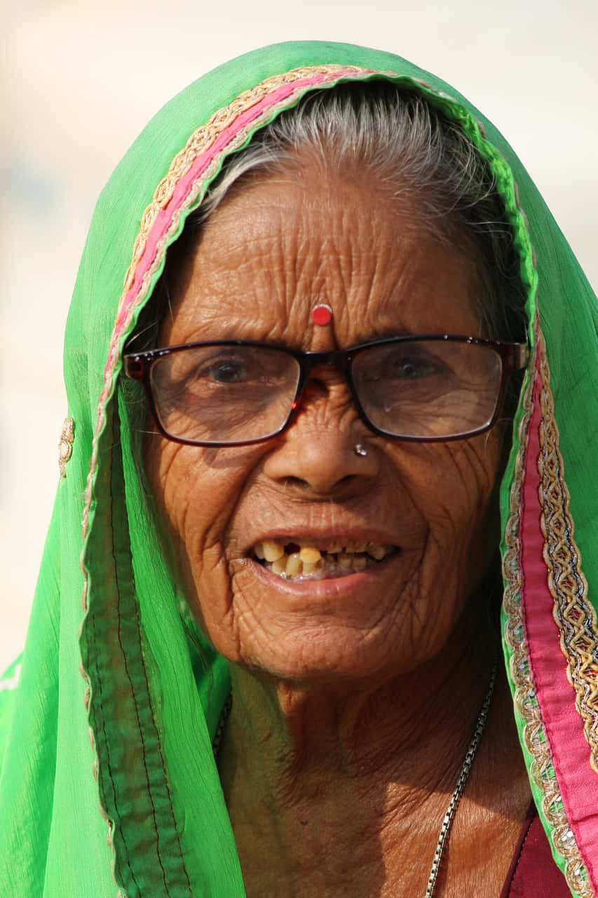 A Gleeful Moment: Senior Indian Lady Radiating With Happiness Background