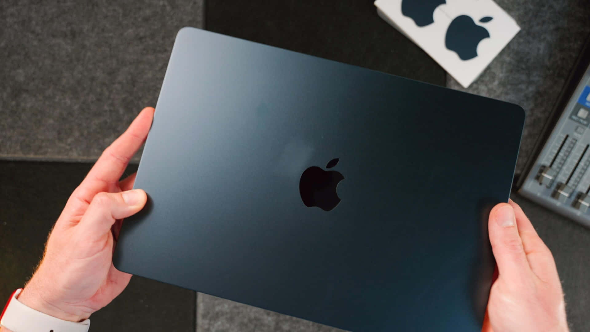 A Glossy Black Macbook Pro With Retina Display Background