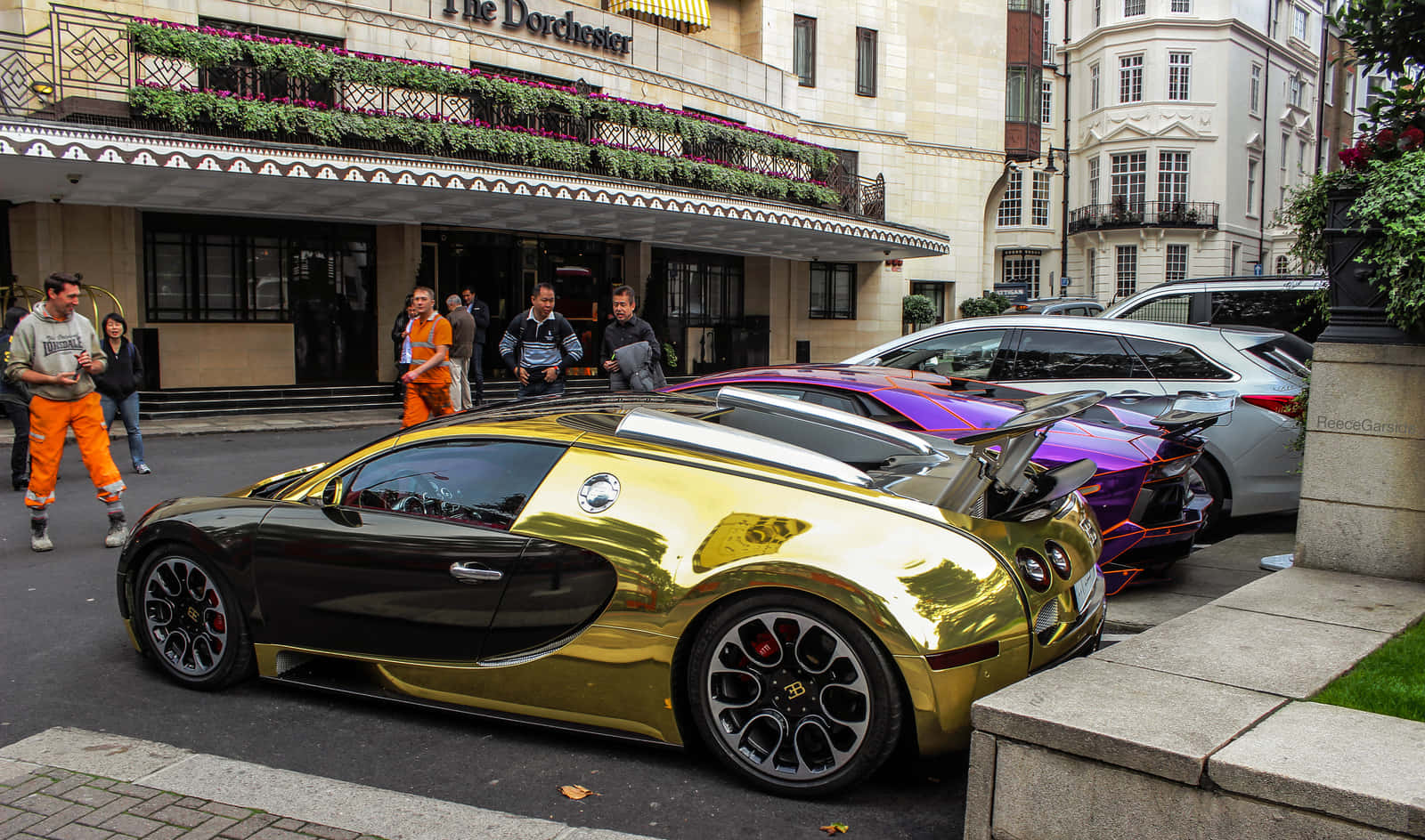 A Gold And Purple Bugatti Veyron Parked On The Street Background