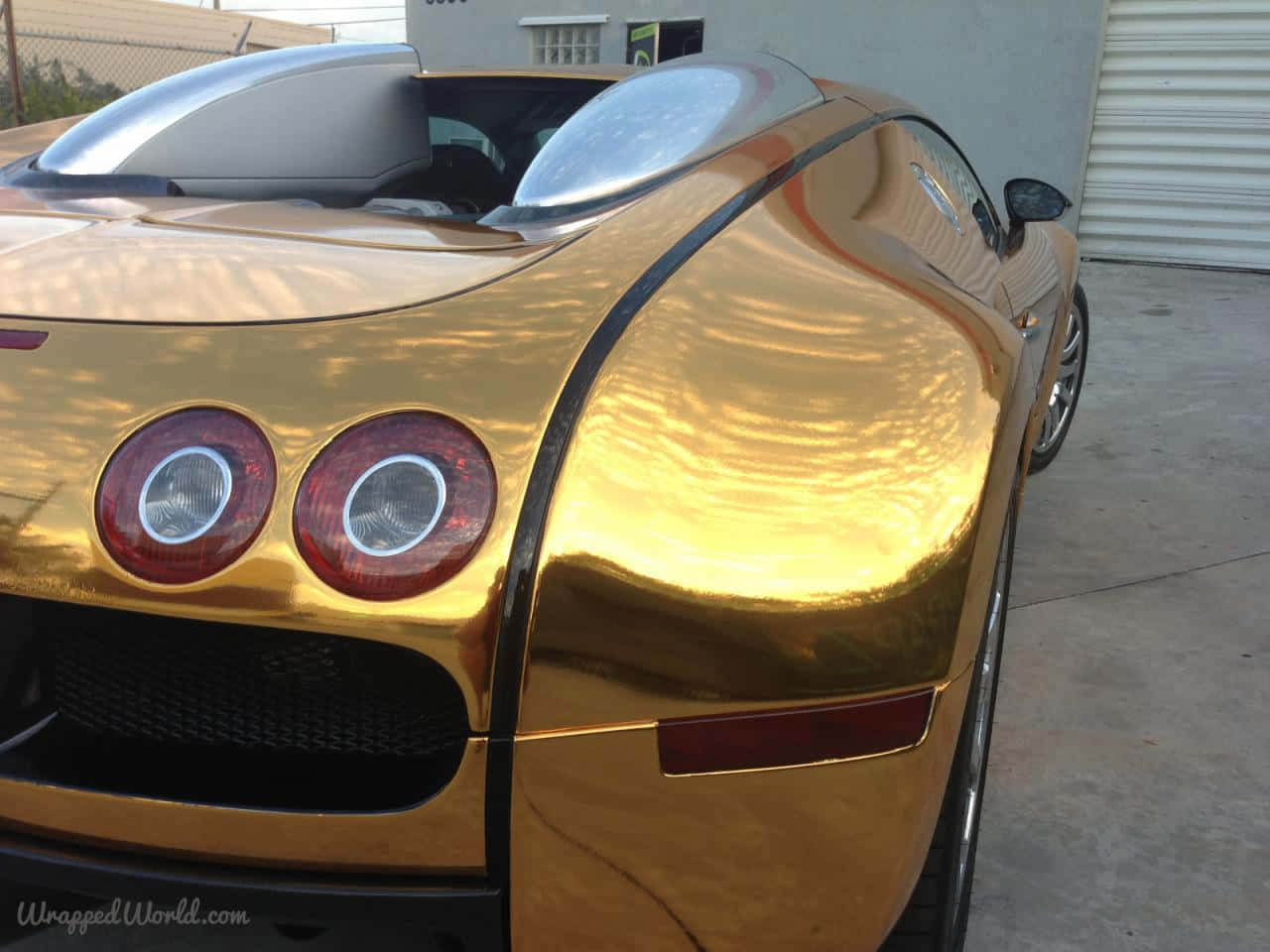 A Gold Bugatti Veyron Parked In A Garage Background