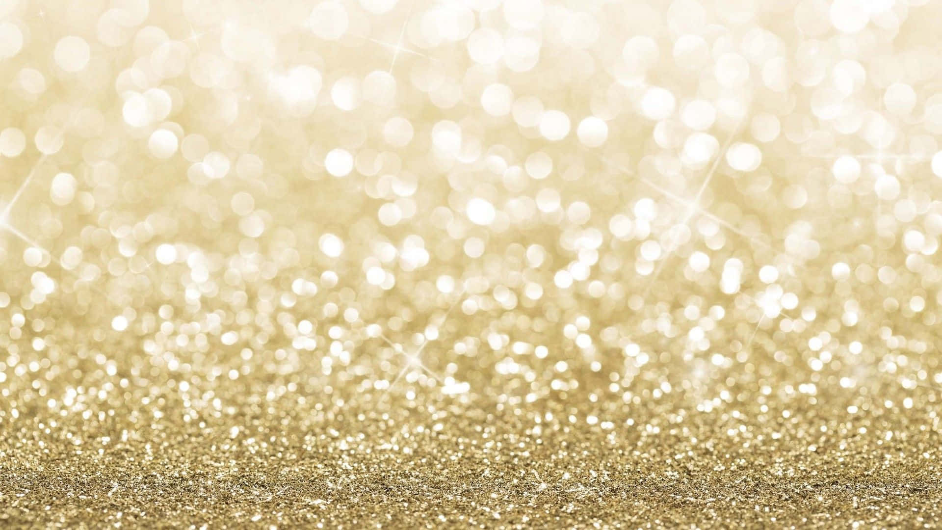 A Gold Glitter Background With Sparkles