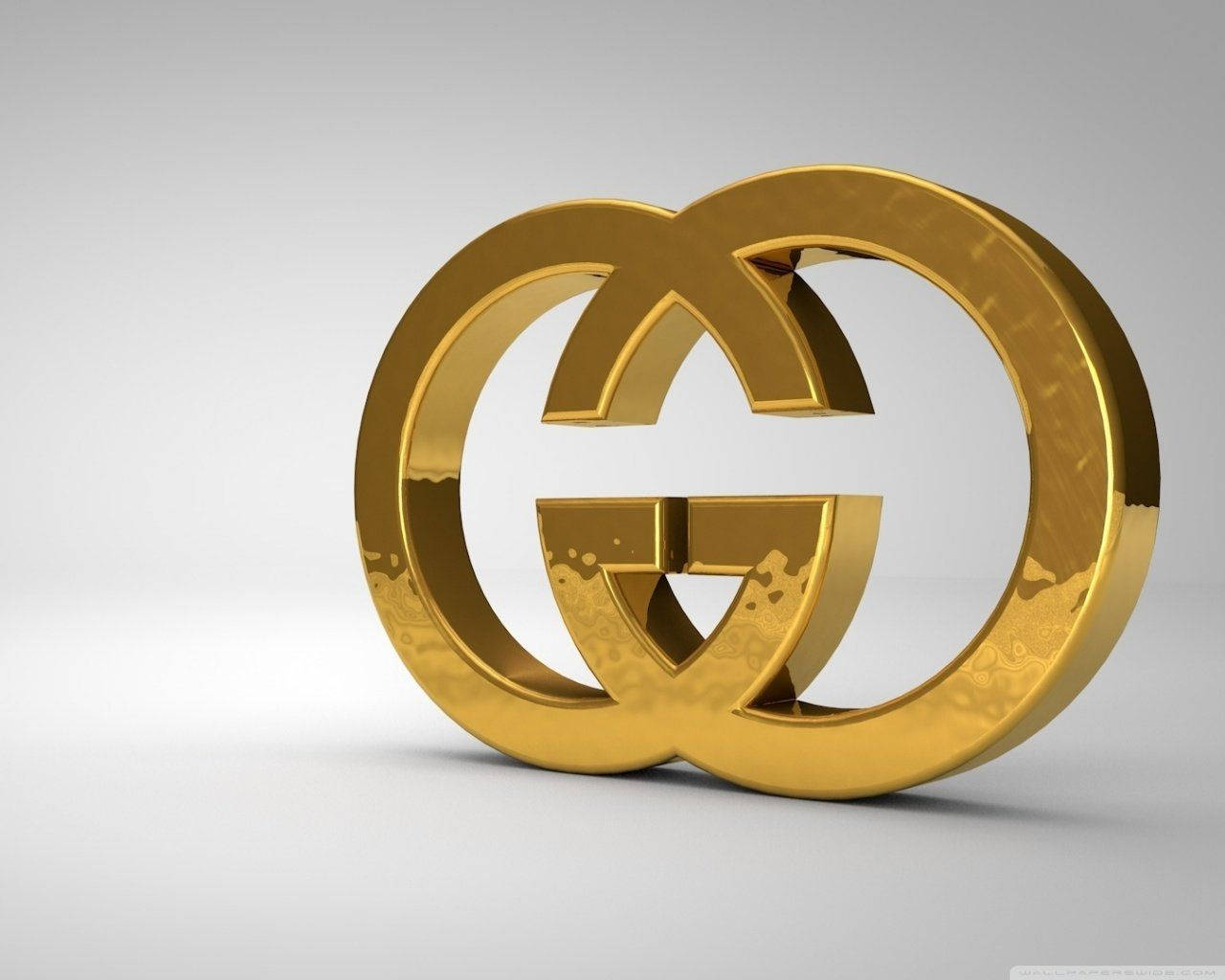 A Gold Gucci Logo On A Gray Background Background