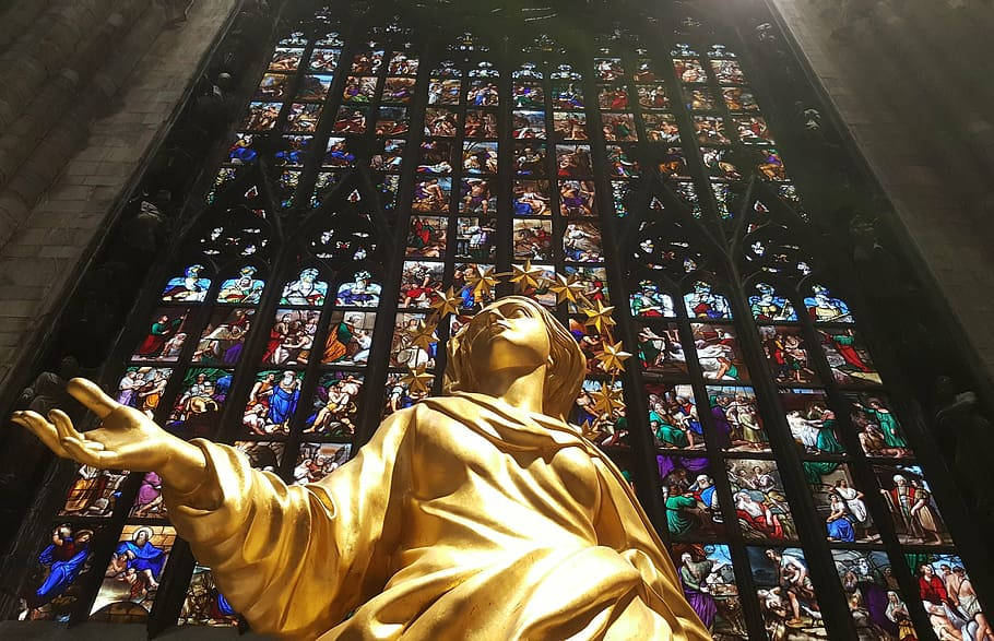 A Gold Statue In Milan Background