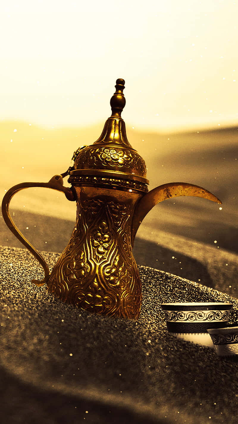 A Gold Teapot In The Sand Background