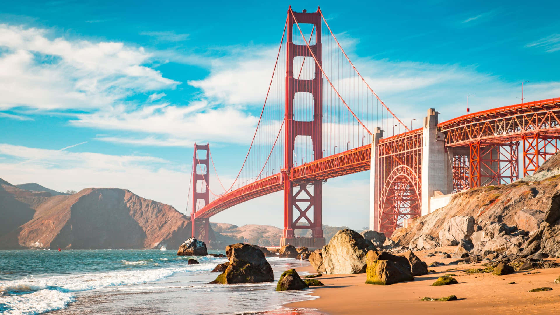 A Golden Gate Bridge Is Seen From The Beach Background