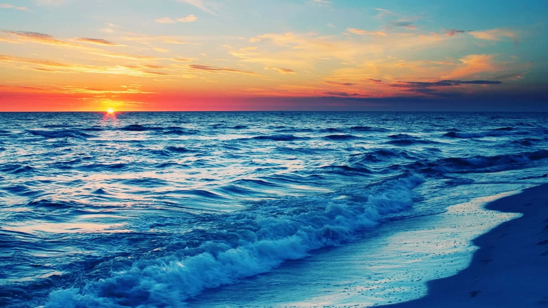 A Golden Sunset Over A Serene Beach Background