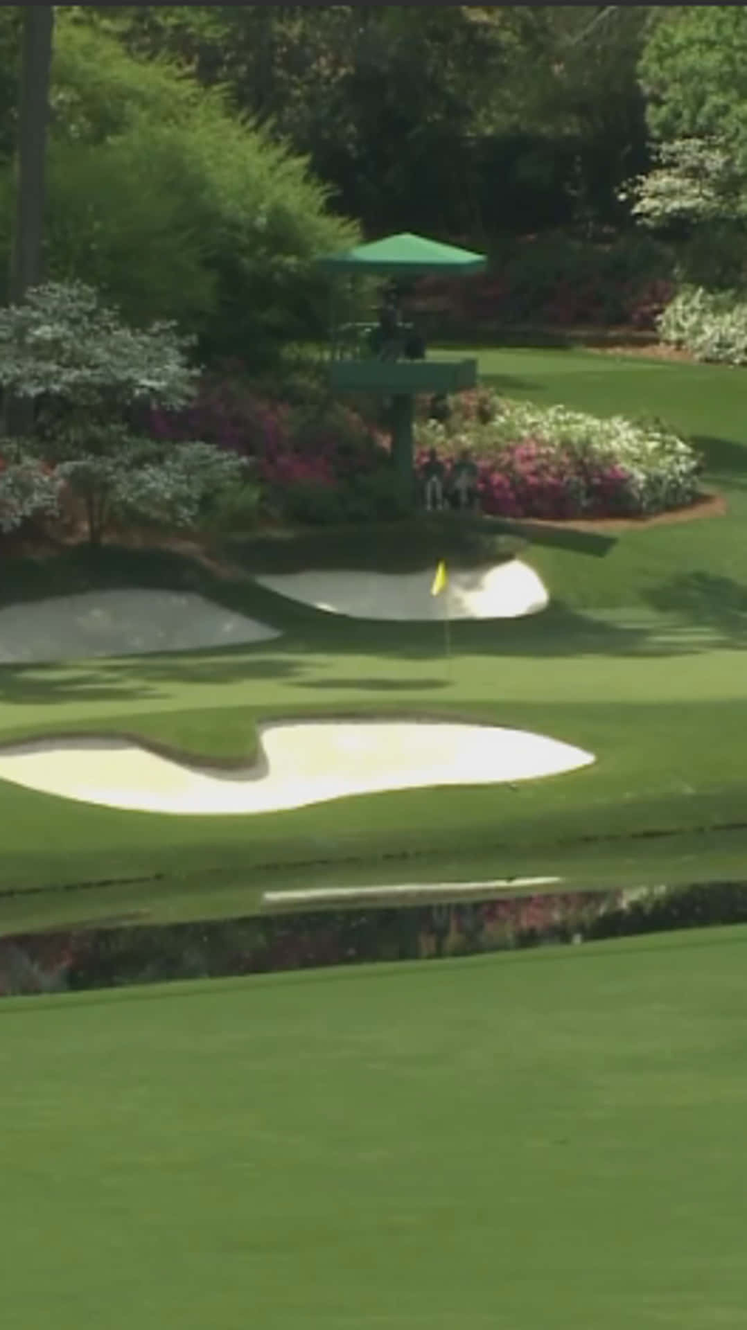 A Golf Course With A Green Tee And A Bunker Background