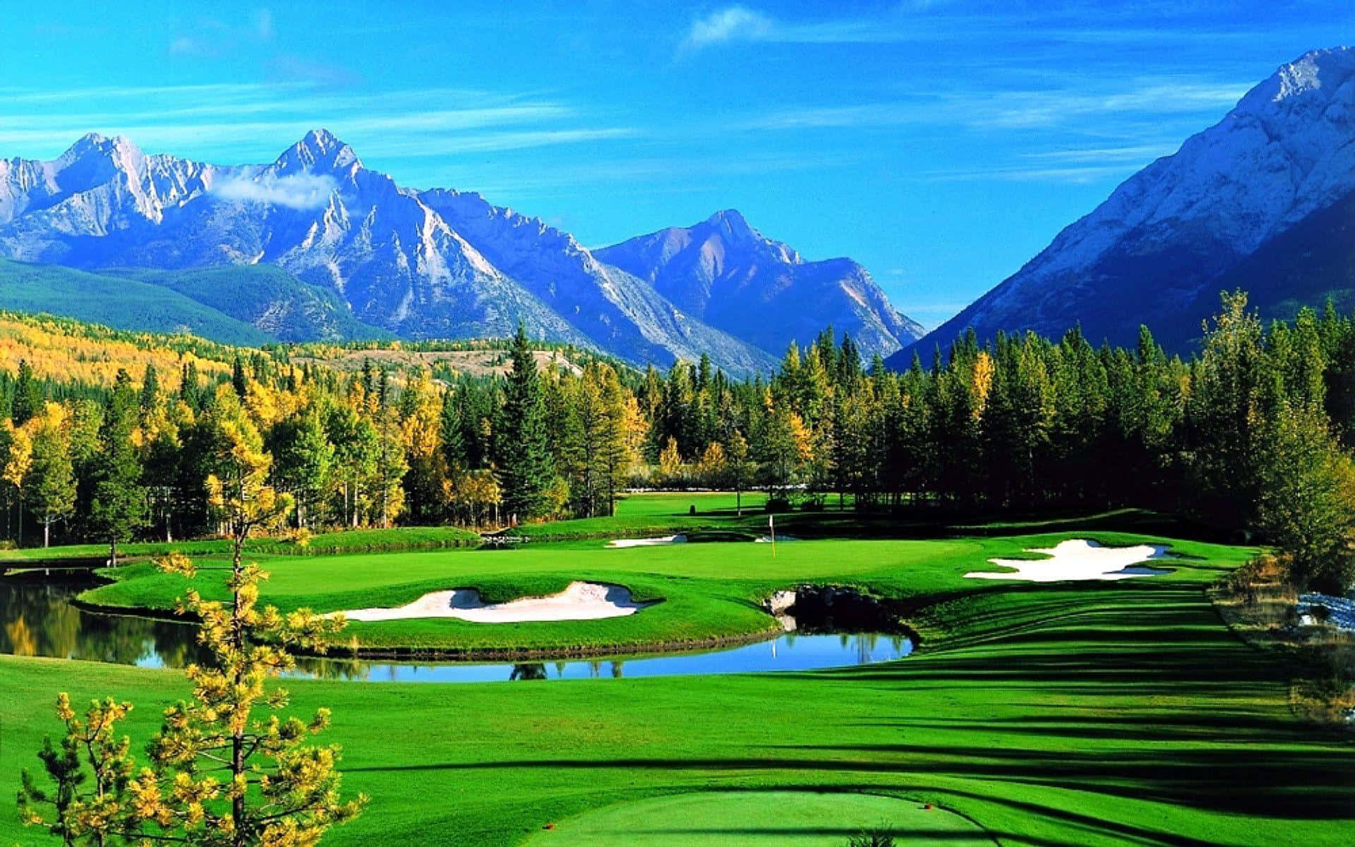 A Golf Course With Mountains In The Background Background