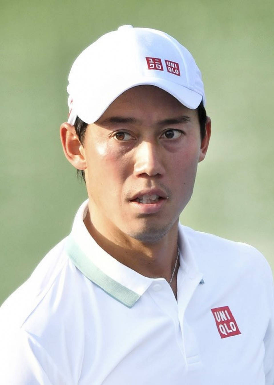 A Golf Player In A White Shirt And Red Cap Background