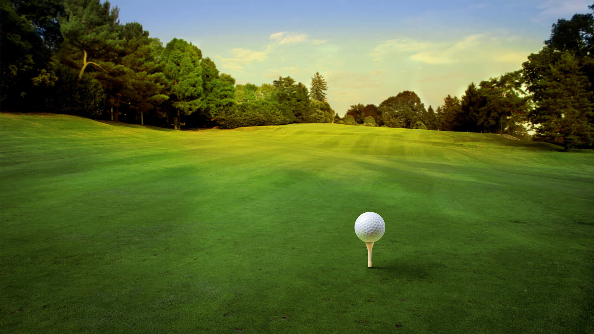 A Golfer Preparing To Swing While Overlooking A Beautiful Course At Sunset. Background