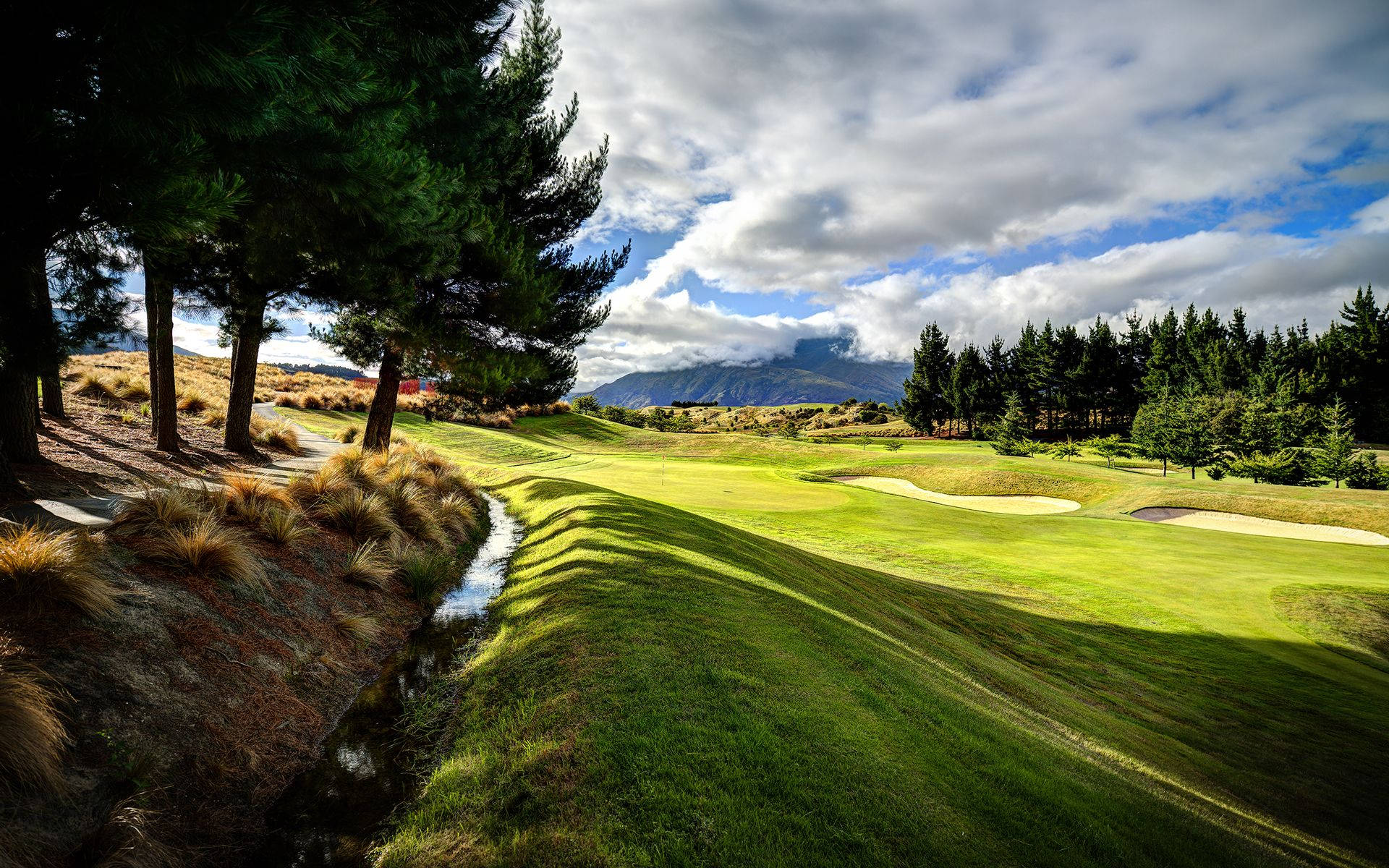 A Golfer Takes A Swing Into Summer Background