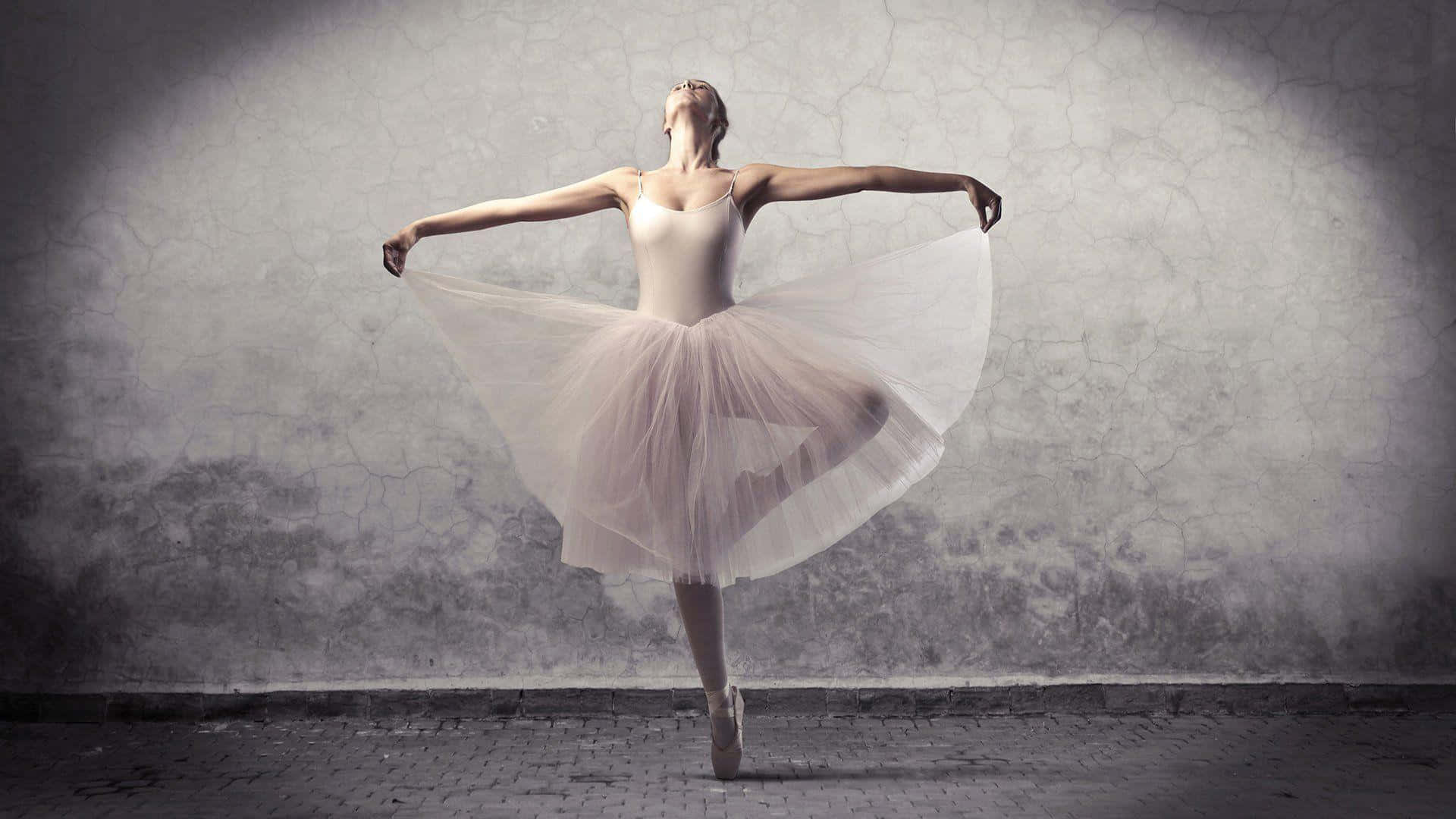 A Graceful Ballerina In Her Pink Pointe Shoes, On Her Toes In The Dreamy Swirl Of A Pirouette Background