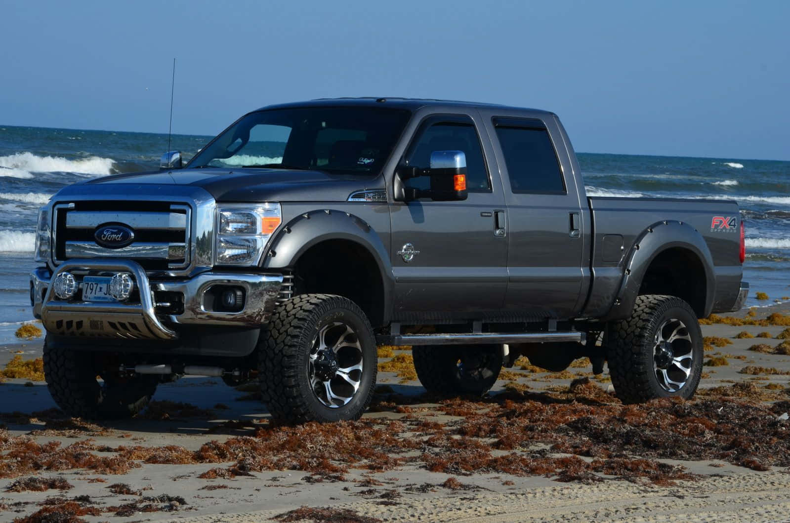 A Gray Truck Is Parked On The Beach