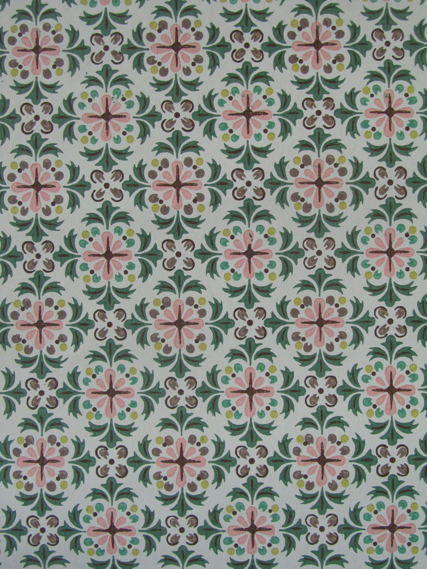 A Green And Pink Tile With Floral Designs