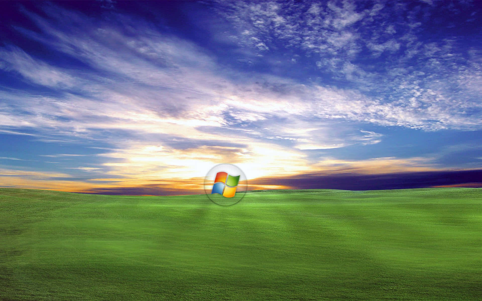 A Green Field With A Blue Sky