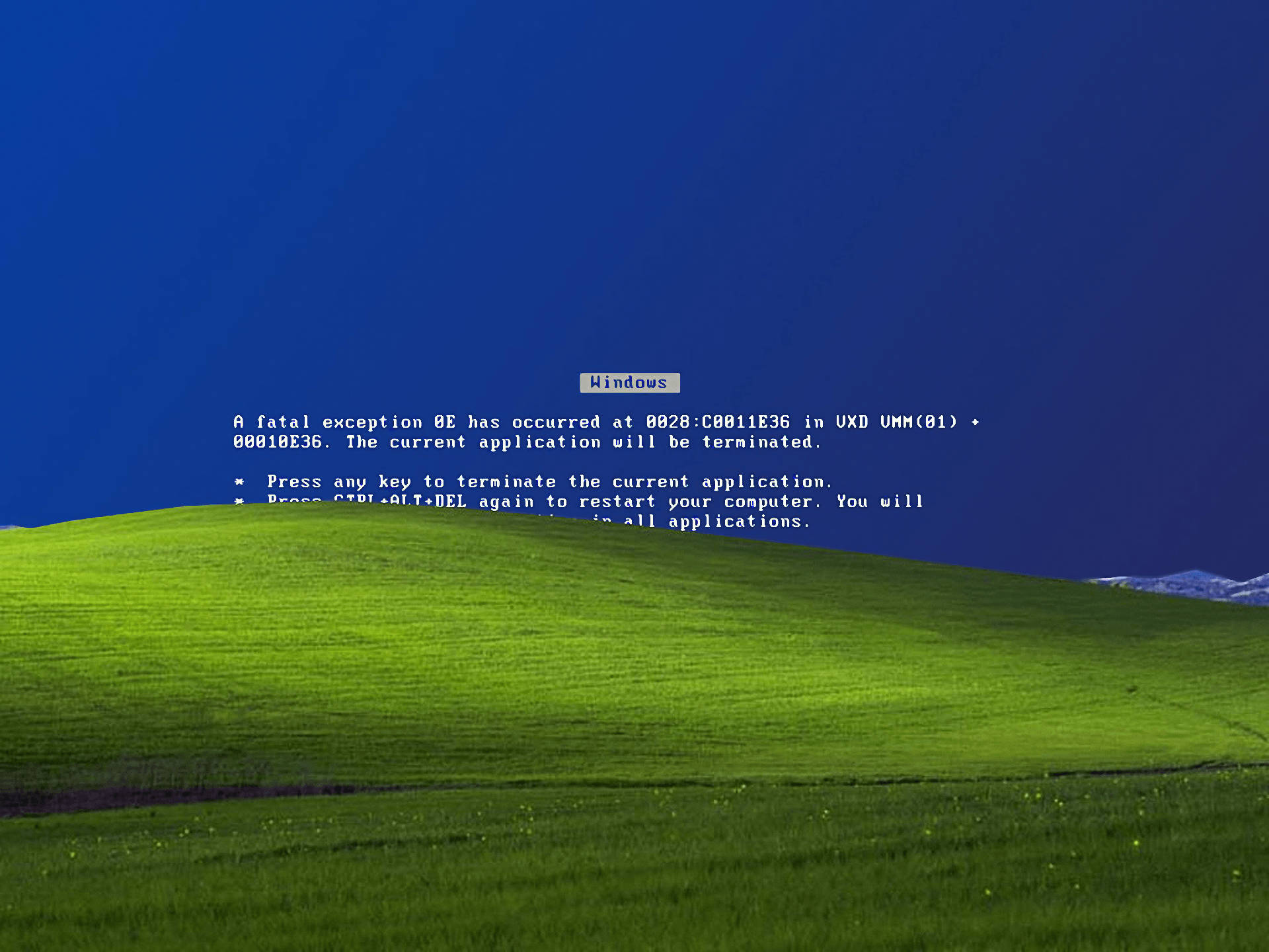 A Green Field With A Blue Sky And A Computer Screen Background
