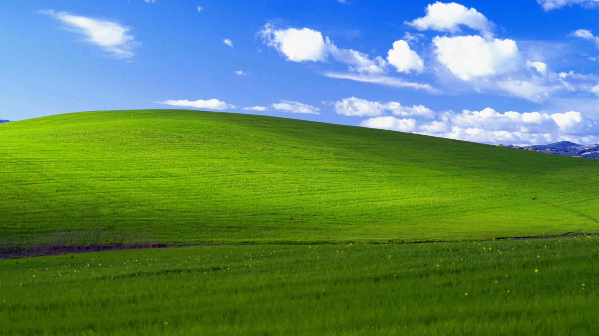 A Green Hill With Blue Sky