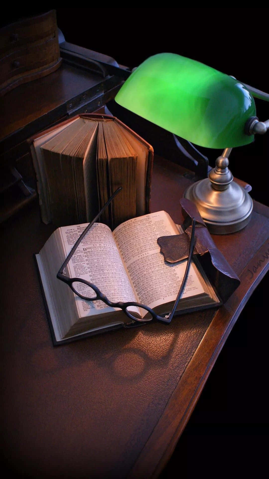 A Green Lamp On A Desk