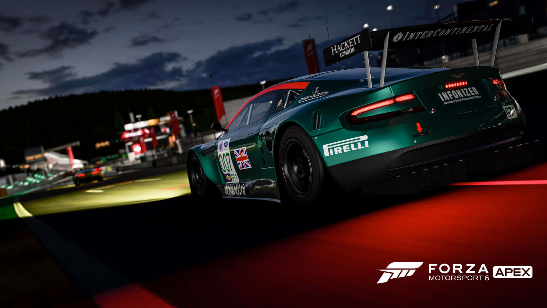 A Green Racing Car Is Driving Down The Track At Night Background