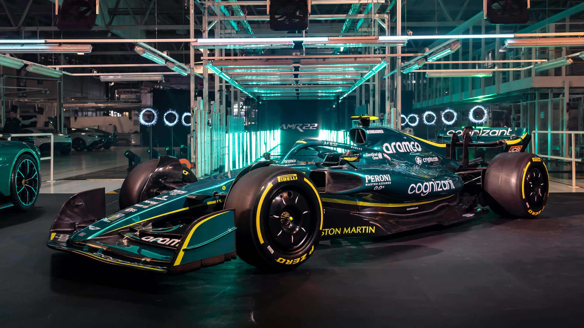 A Green Racing Car Is On Display In A Garage Background