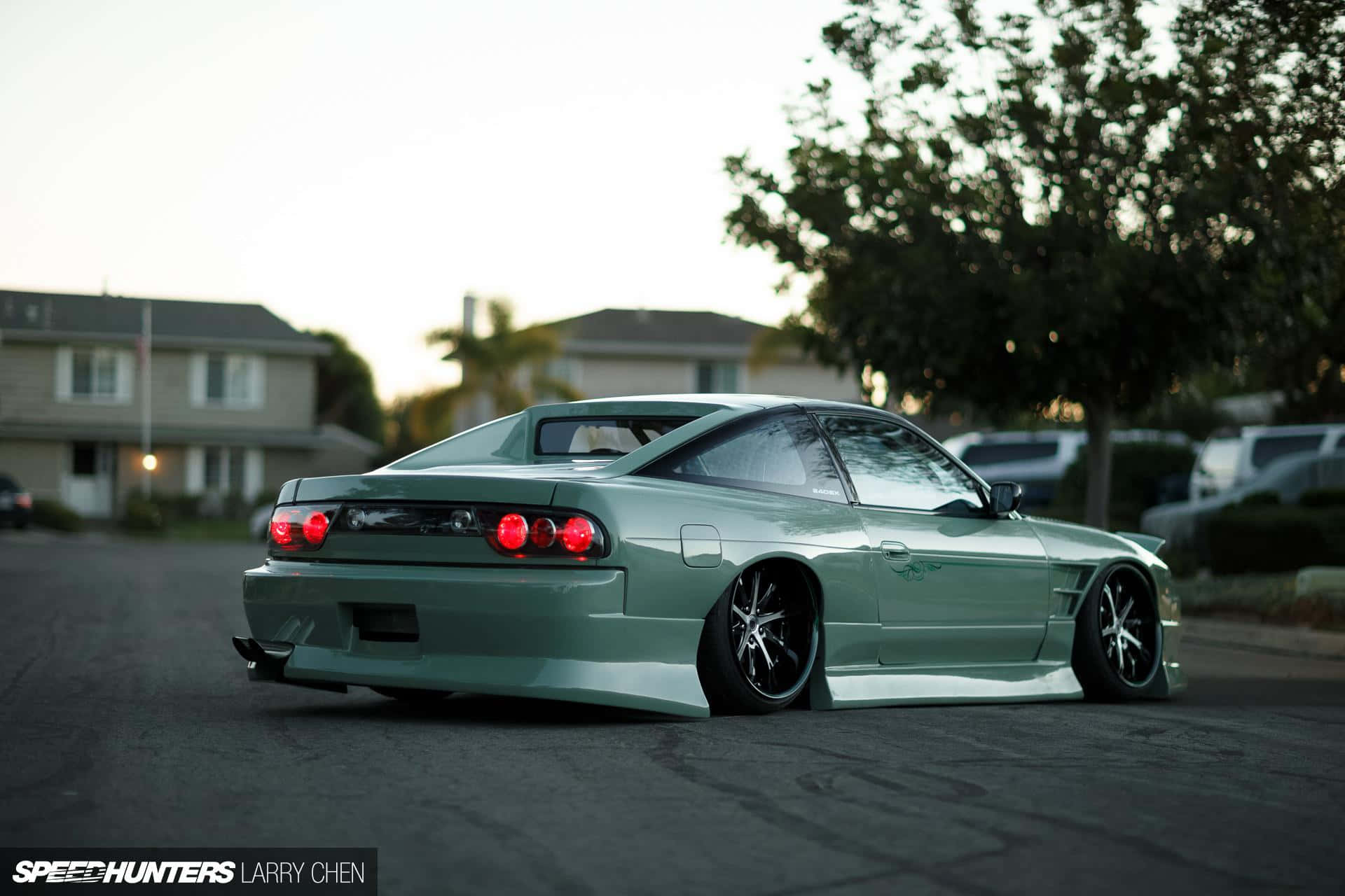 A Green Sports Car Parked On A Street Background