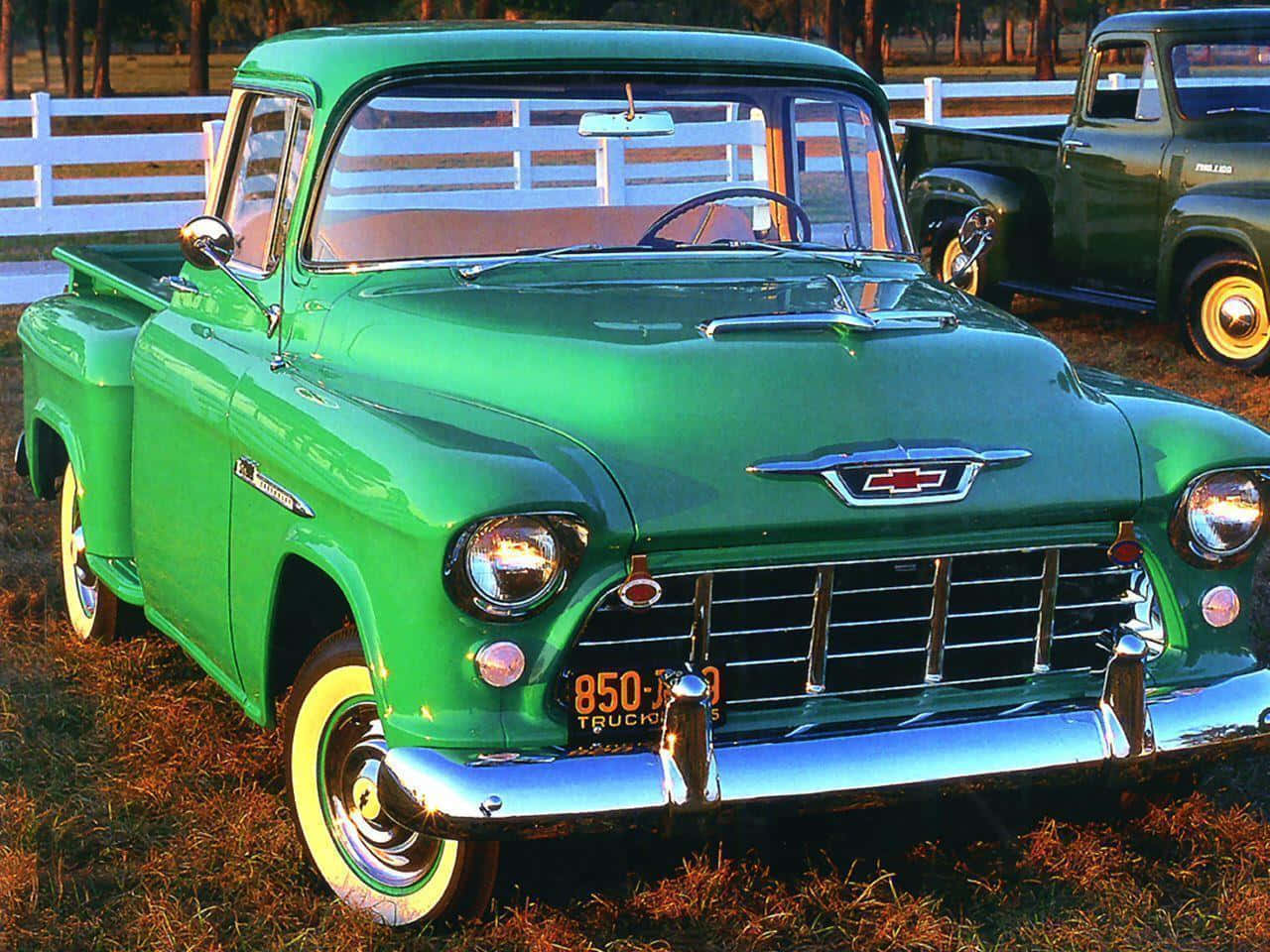 A Green Truck Parked In The Grass Background