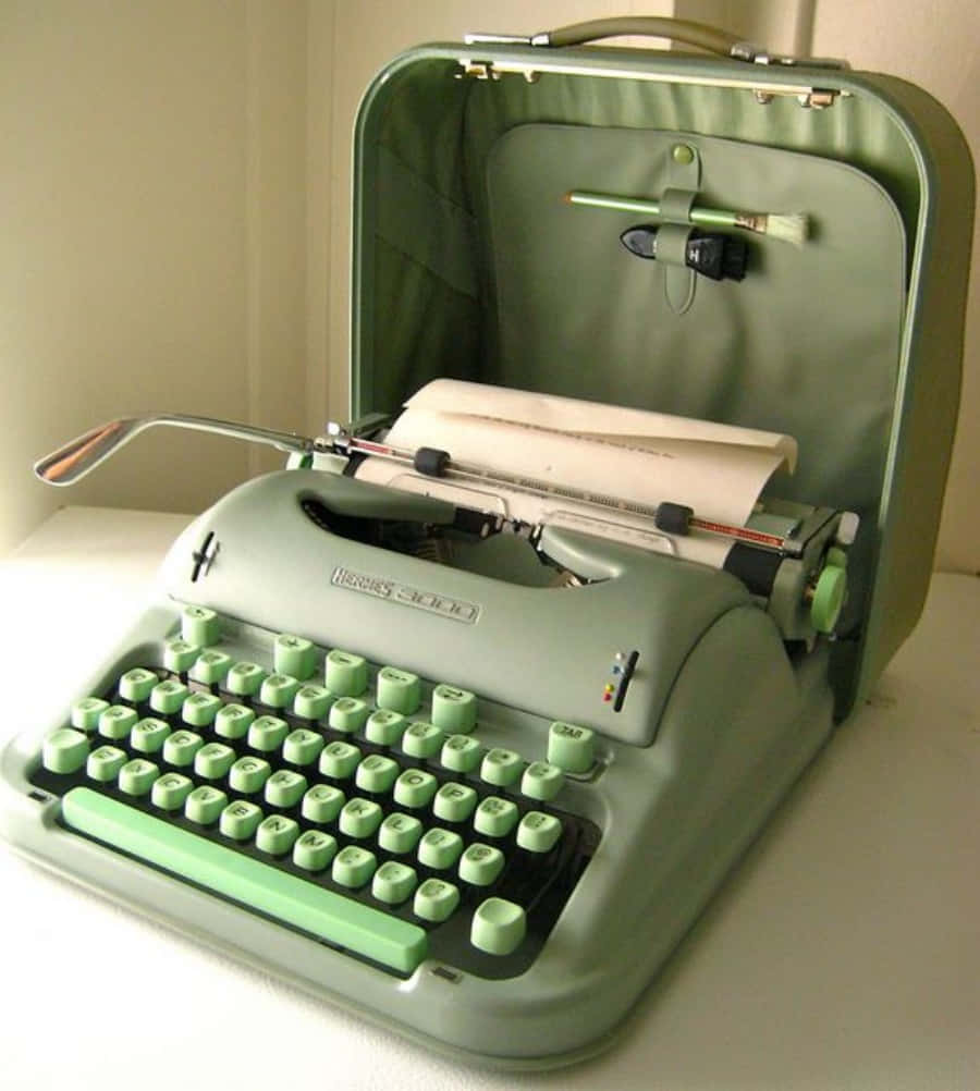 A Green Typewriter With A Paper In It Background