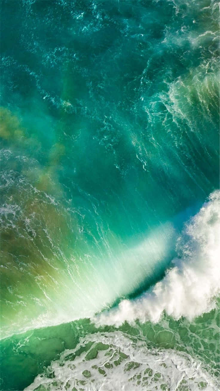 A Green Wave Is Crashing Into The Ocean Background