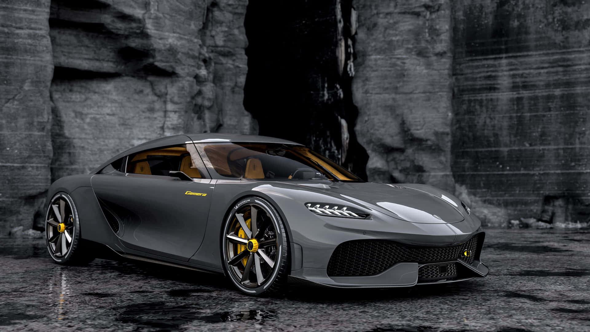A Grey Sports Car Is Parked In Front Of A Rock