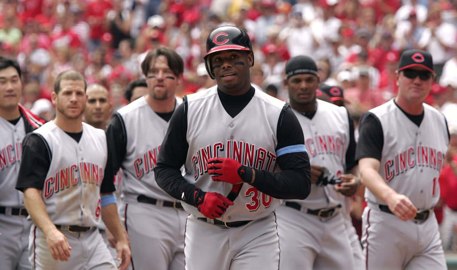 A Group Of Baseball Players Walking On A Field Background