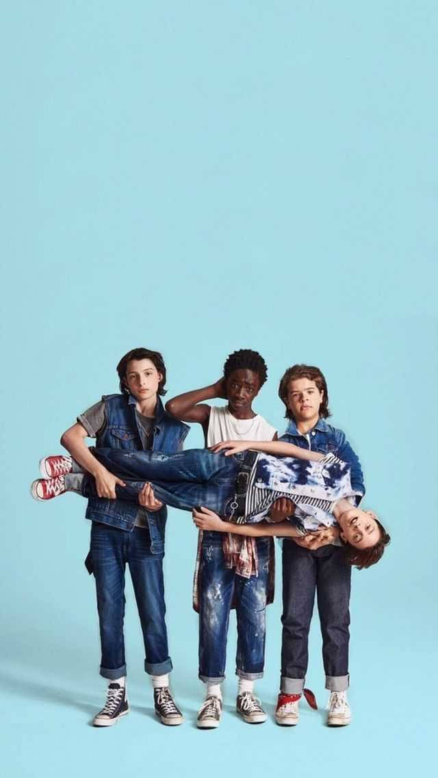 A Group Of Boys Are Standing On A Blue Background Background