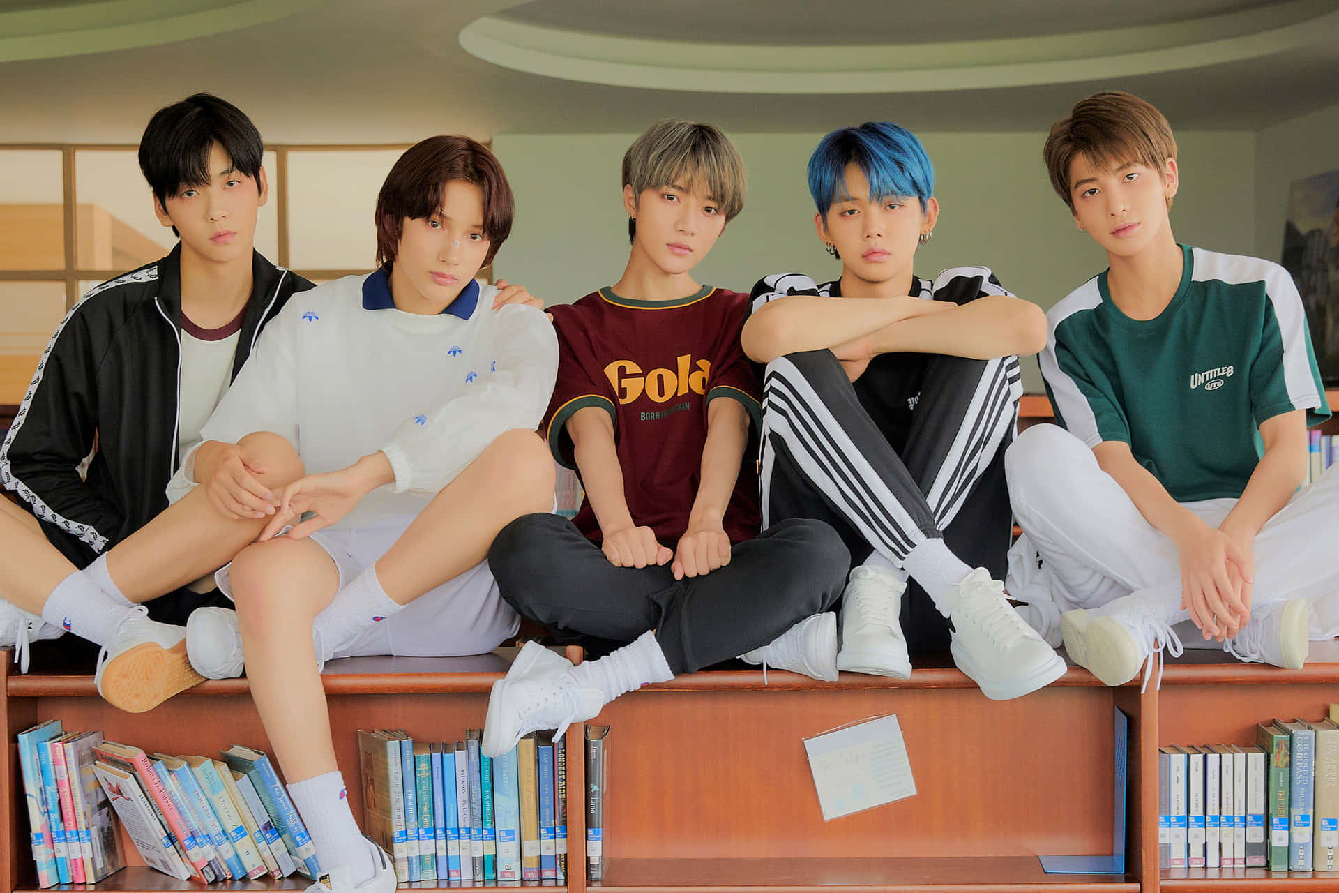 A Group Of Boys Sitting On A Shelf Background