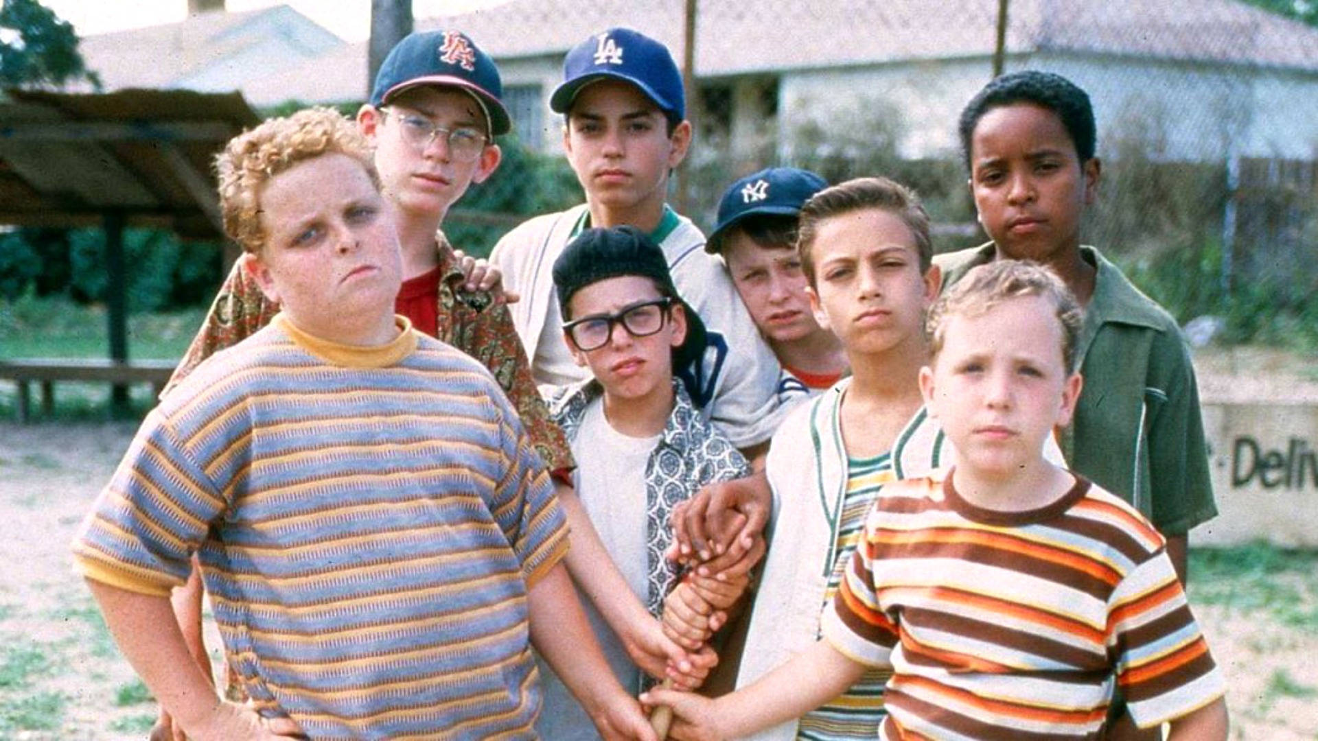 A Group Of Boys Standing Together In A Field Background