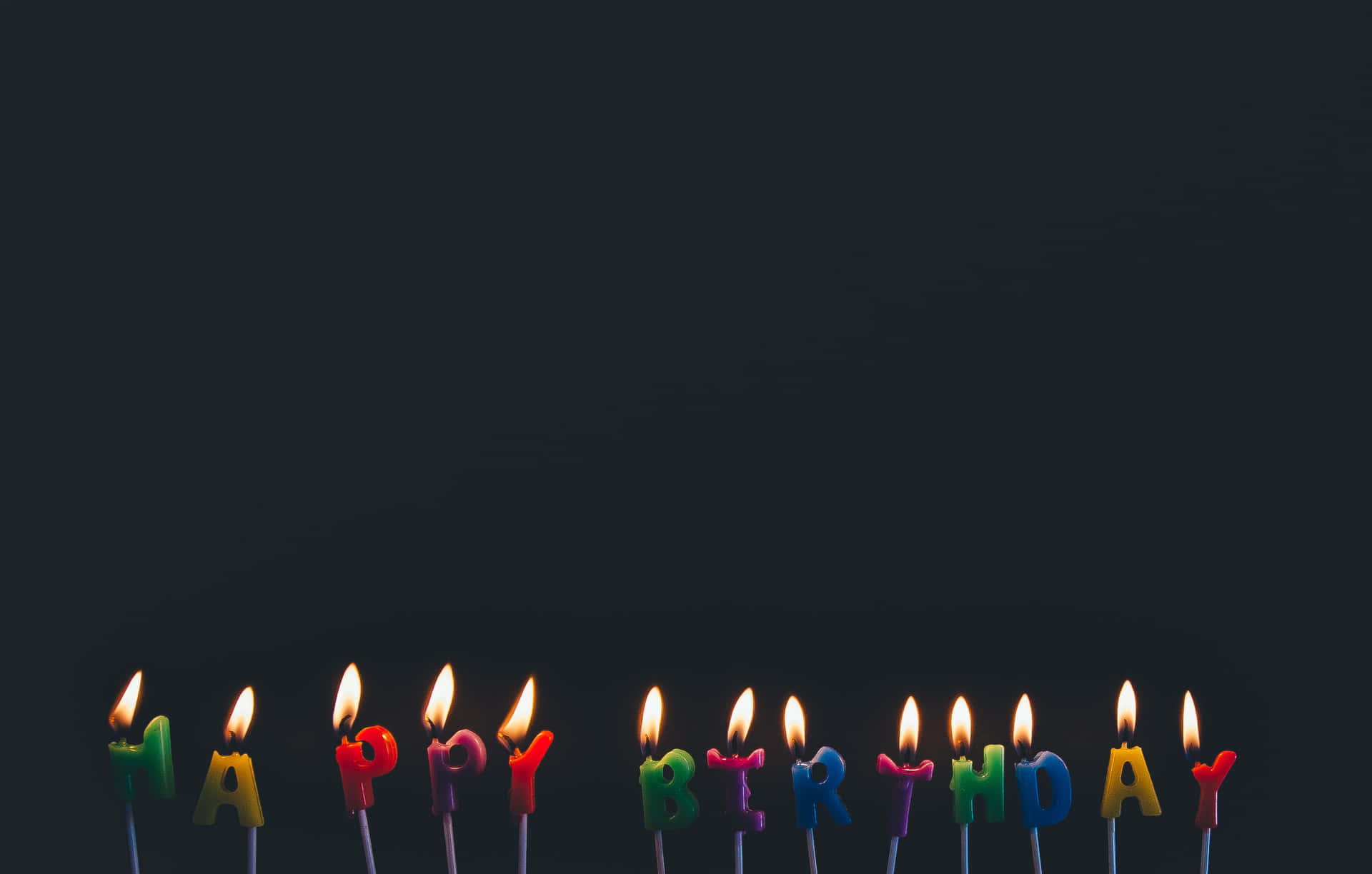 A Group Of Candles With Happy Birthday Written On Them Background