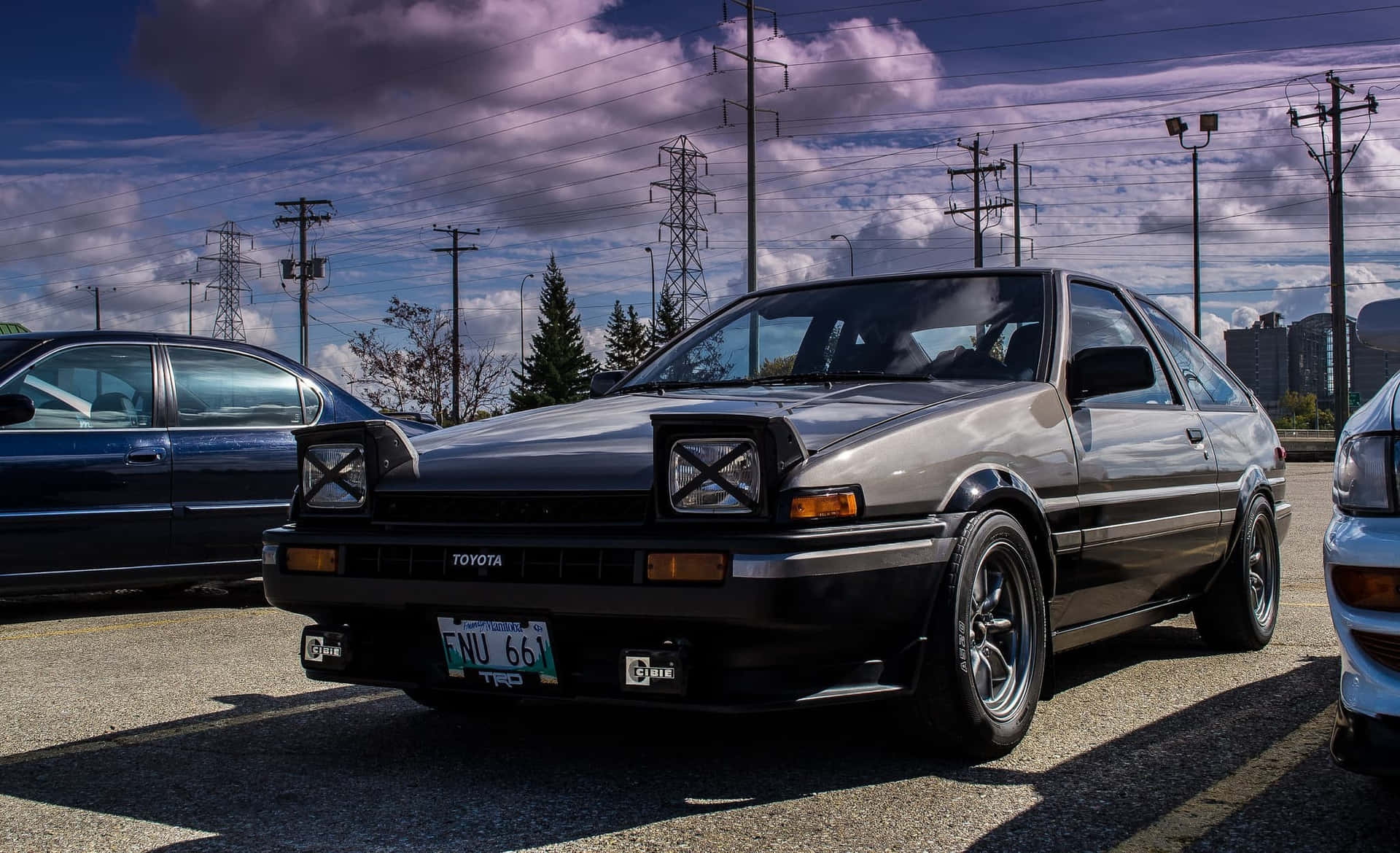 A Group Of Cars Parked In A Parking Lot Background