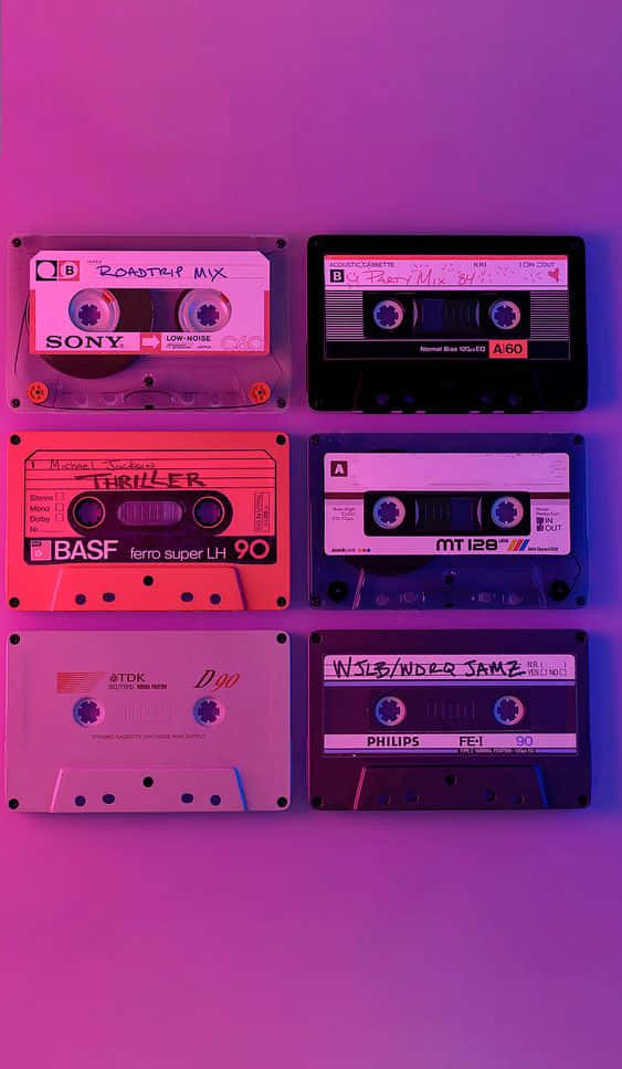 A Group Of Cassettes On A Purple Background