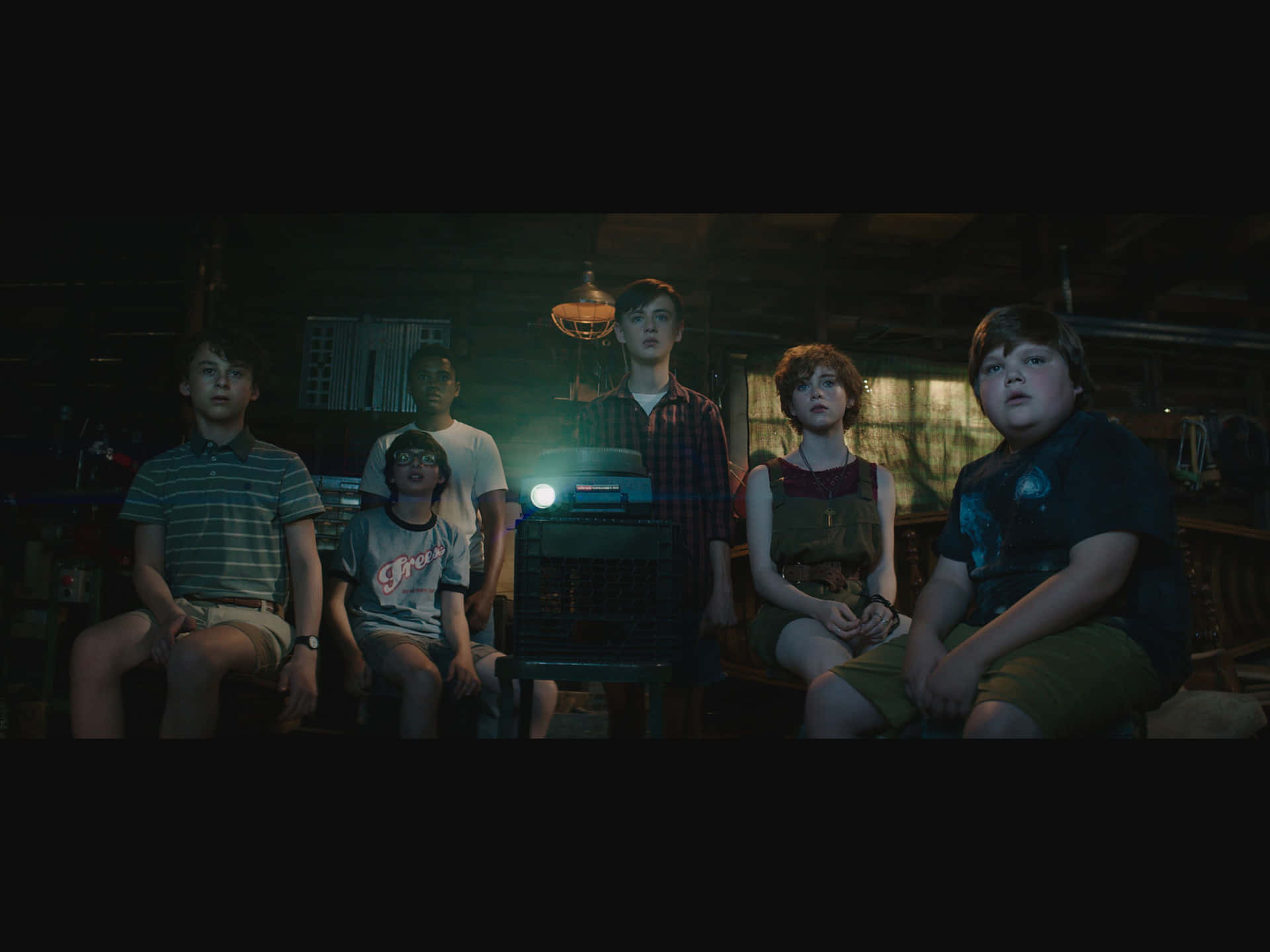A Group Of Children Are Sitting In A Dark Room Background