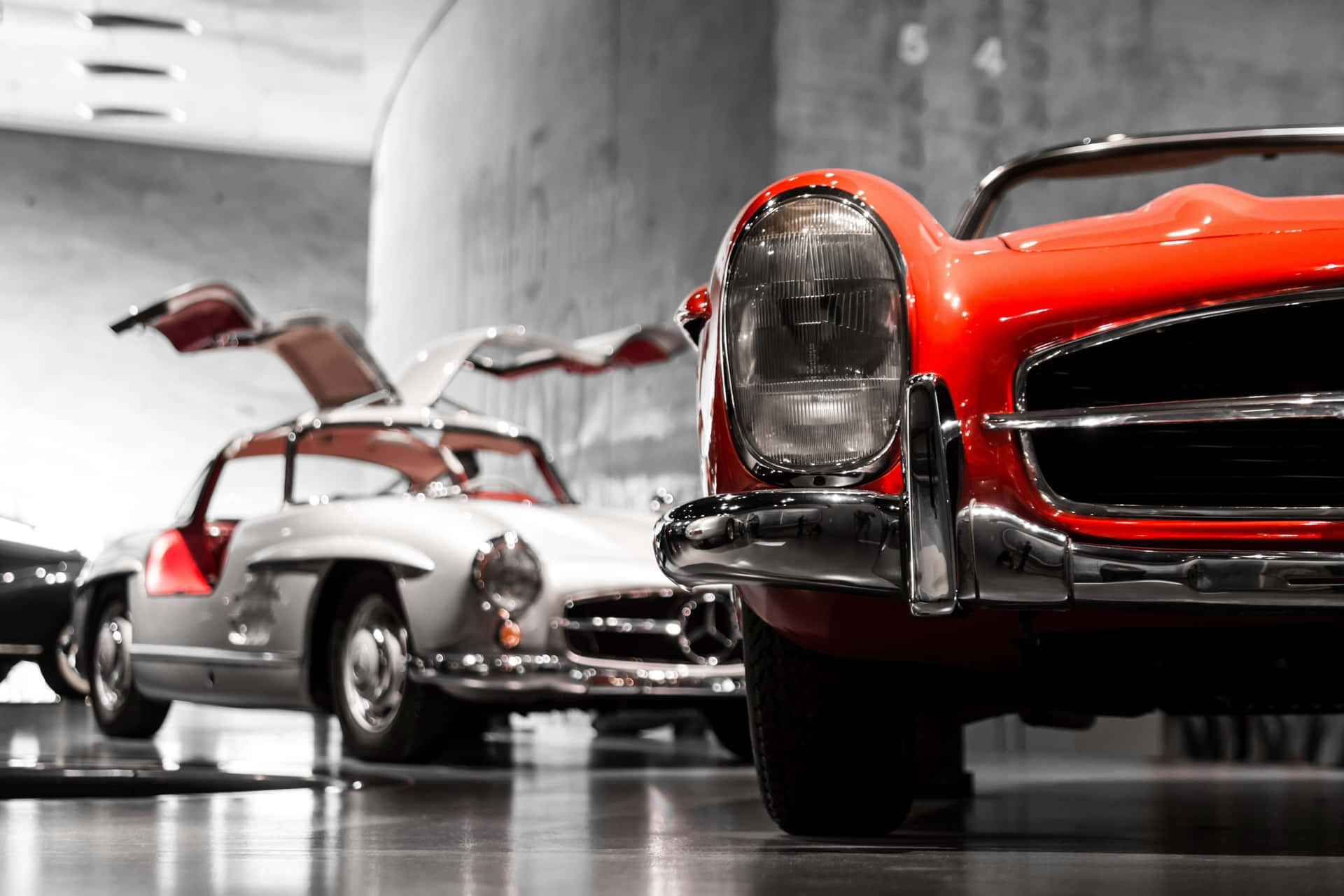 A Group Of Classic Cars In A Museum Background