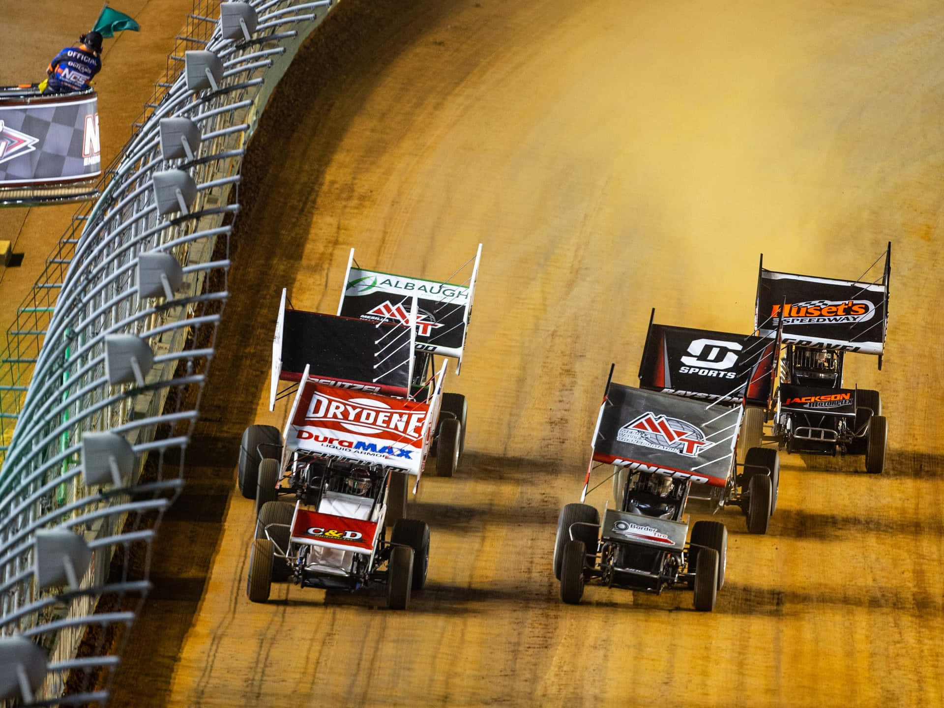 A Group Of Dirt Track Cars Racing Background