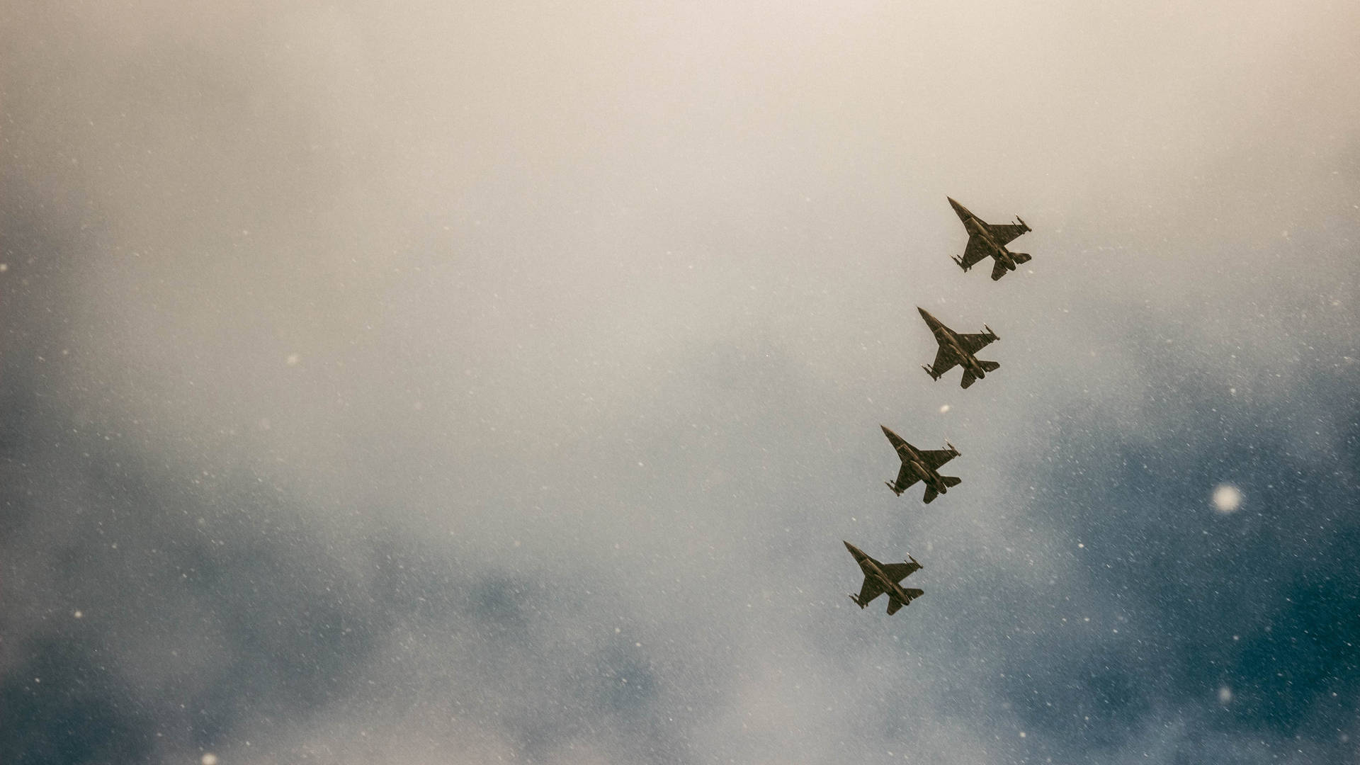 A Group Of Fighter Jets Flying In The Sky Background