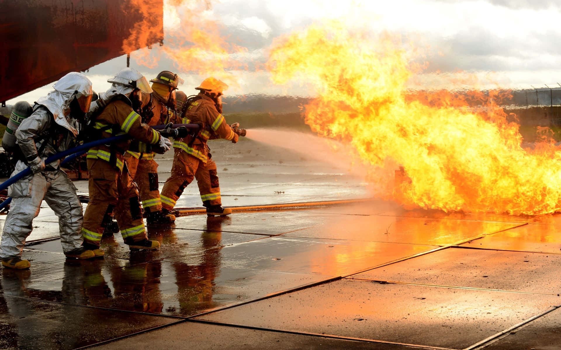 A Group Of Firefighters Are Battling A Fire Background