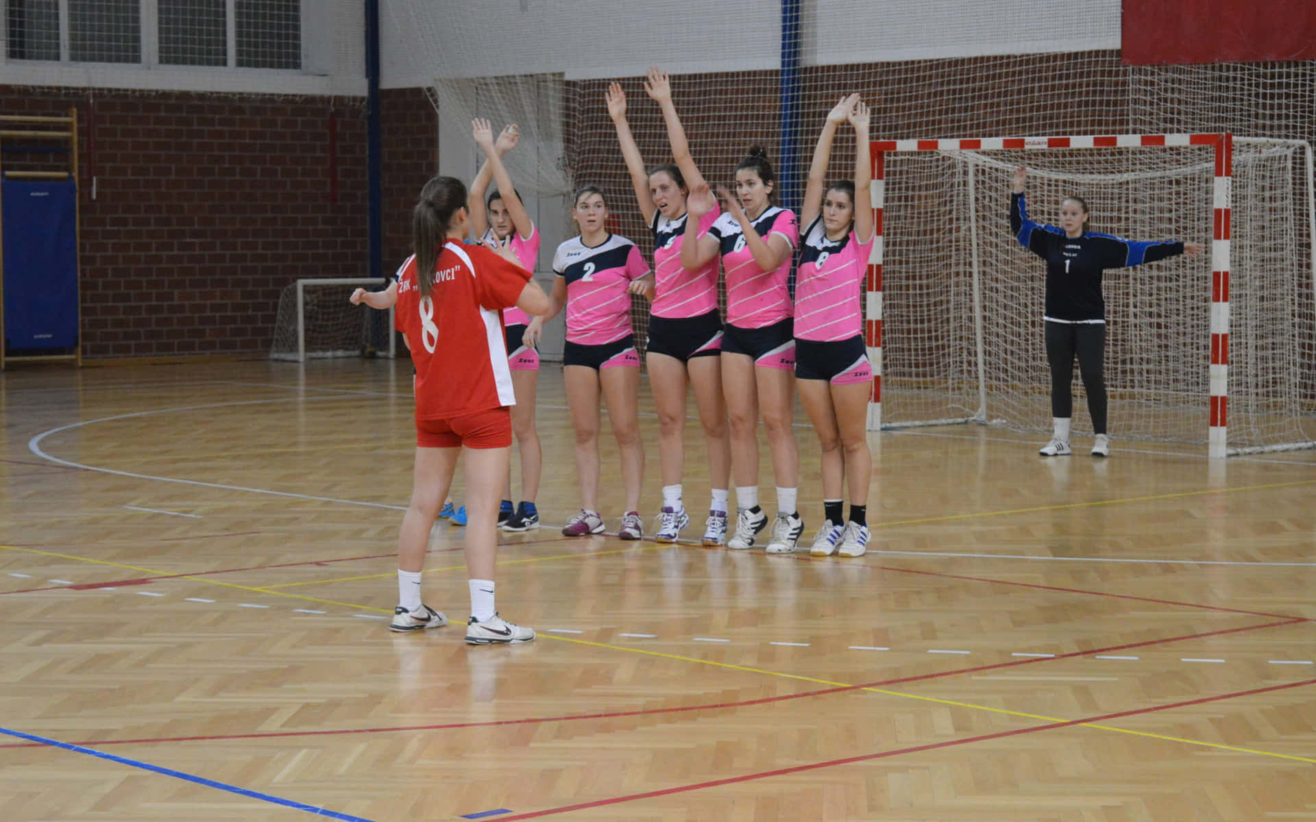 A Group Of Girls Playing Volleyball Background