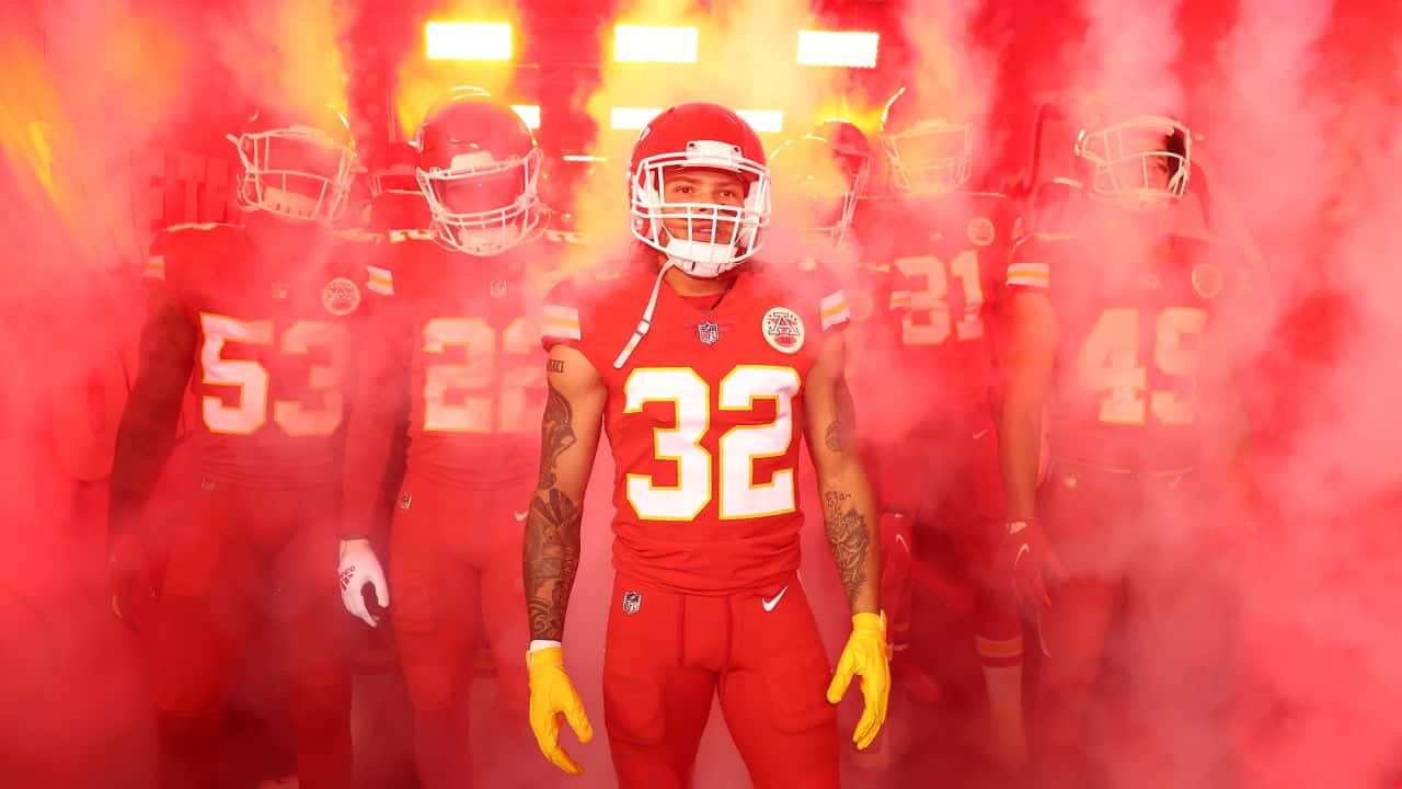 A Group Of Kansas Chiefs Players Standing In Front Of Smoke Background